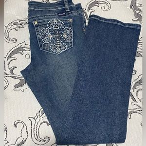 The brand is Seven7, youth size 14, 2 pairs of pants, bootcut style.